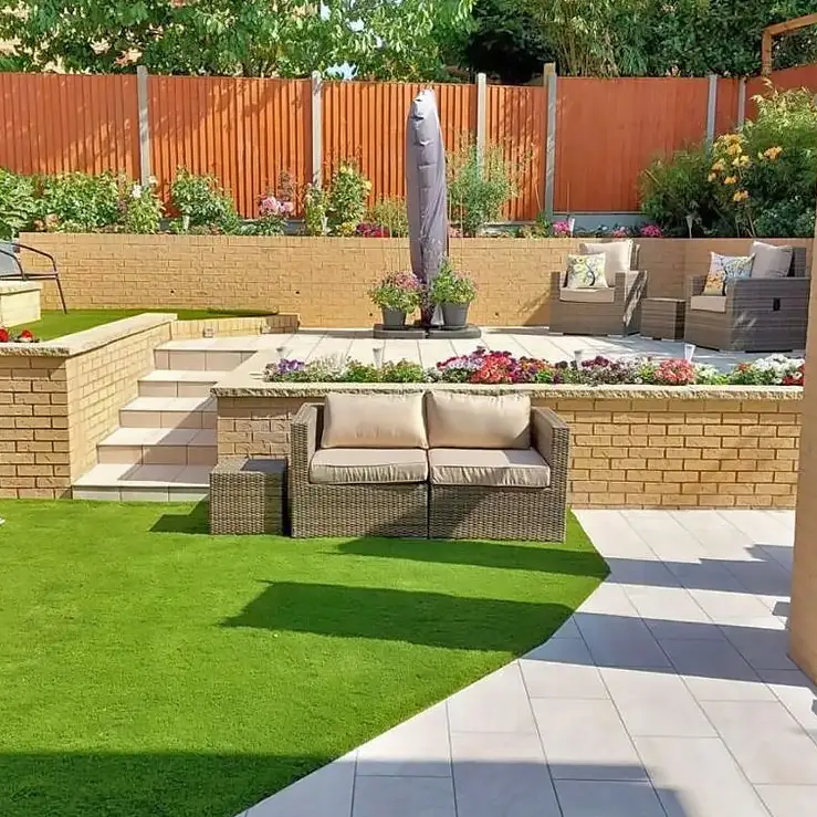 Garden patio with artificial grass and bricked area designed by N.Farr Ltd